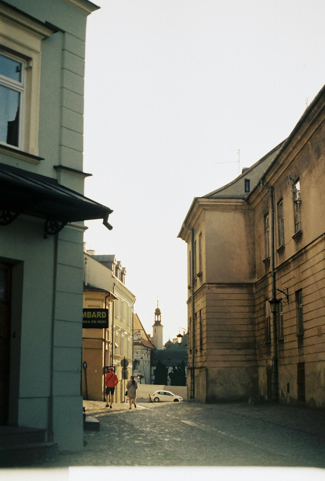 Documentary photographer photographing a street scene in a small Polish town
