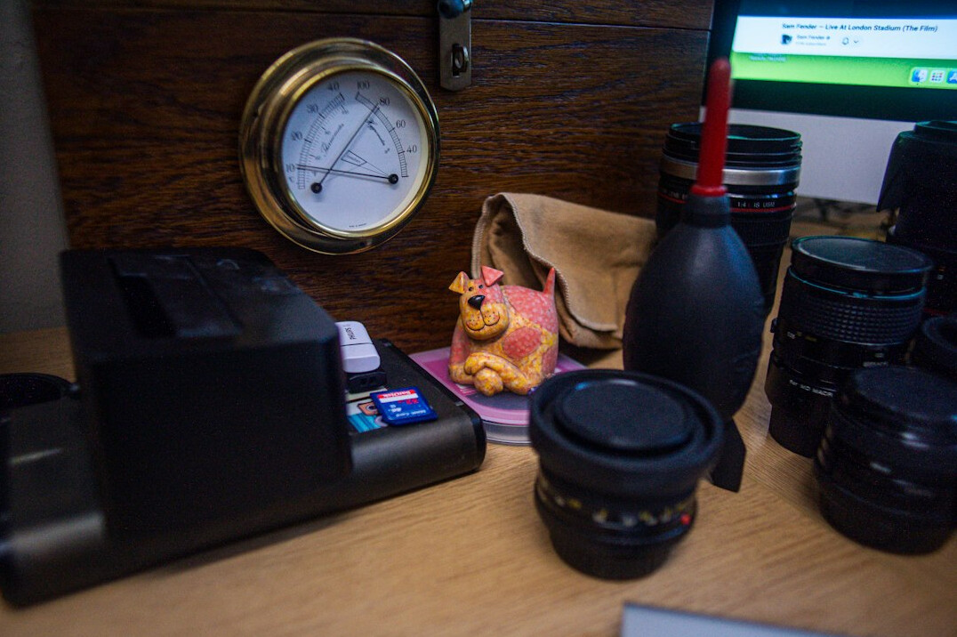 Photography studio desk with camera equipment and notebooks