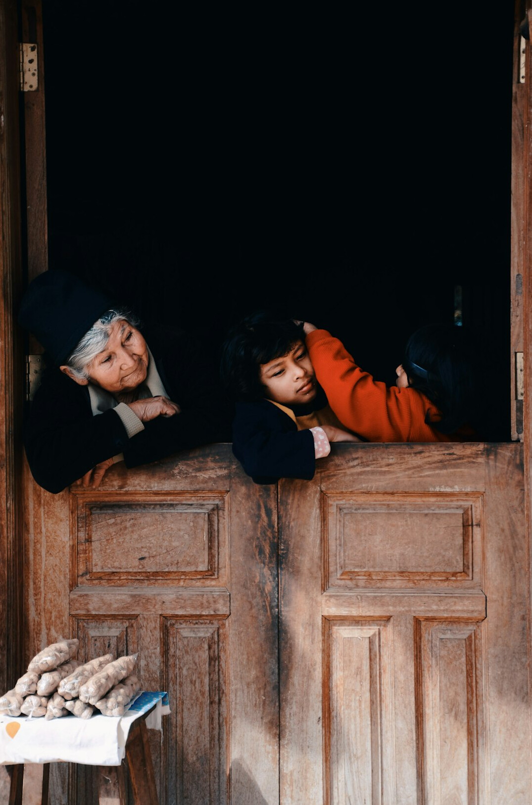 Polish family sitting together at a wooden table in a rural home